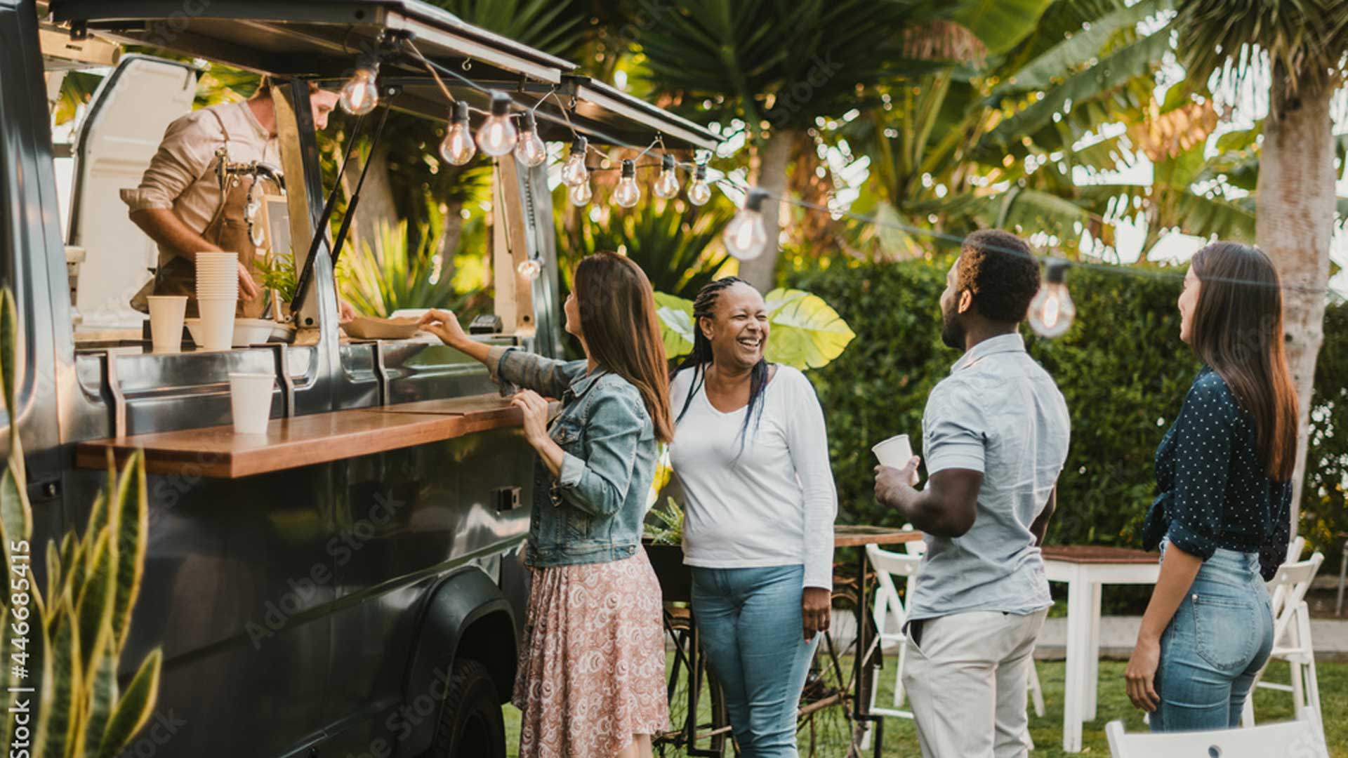 people standing in line to get their food from a van food truck 